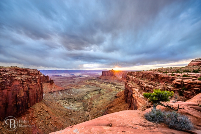 The sun pokes through over an epic landscape in Canyonlands National Park